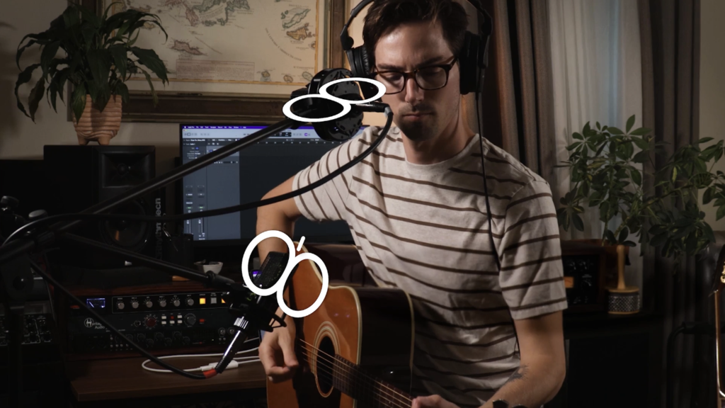 Condenser microphones on acoustic guitar player
