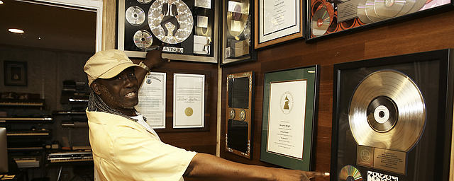 Benjamin Wright showing his Gold and Platinum Records