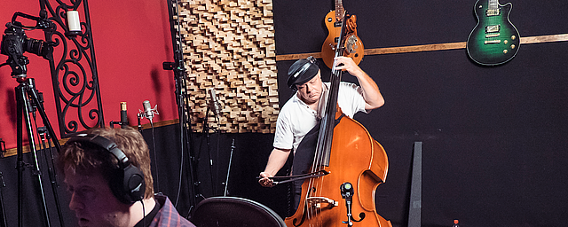 Brandino playing the upright bass at the microphone shootout