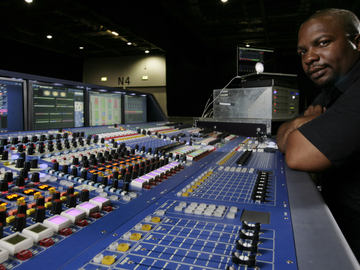 This image shows Schon Emmanuel in studio on his mixing console