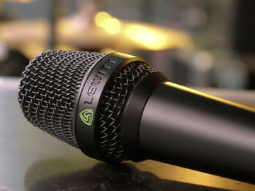 This image shows the MTP 840 DM live performance microphone on stage