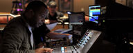 This image shows Schon Emmanuel in studio on his mixing console