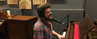 This image shows Steve Maggiora from Robert Jon & The Wreck at the piano in hybrid studios singing into an MTP 740 CM